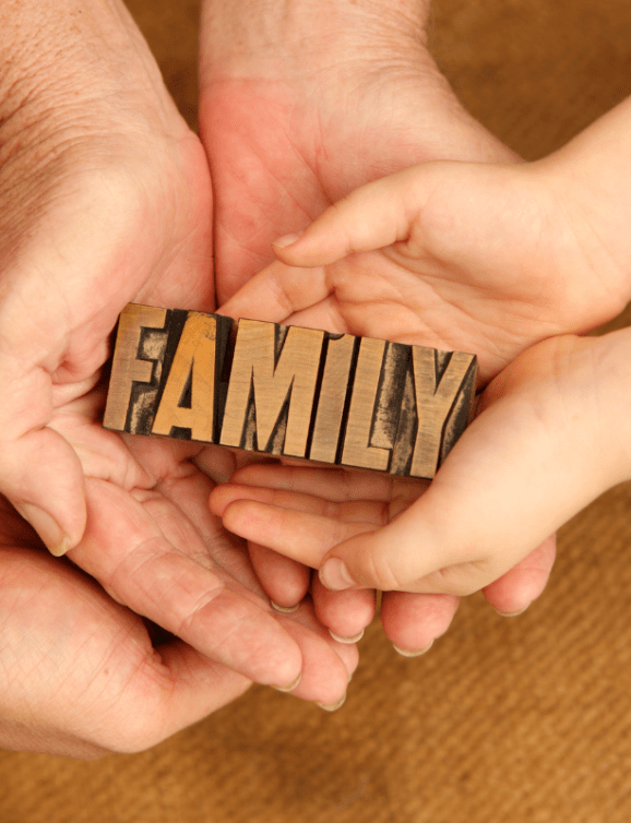 Hands holding a family sign