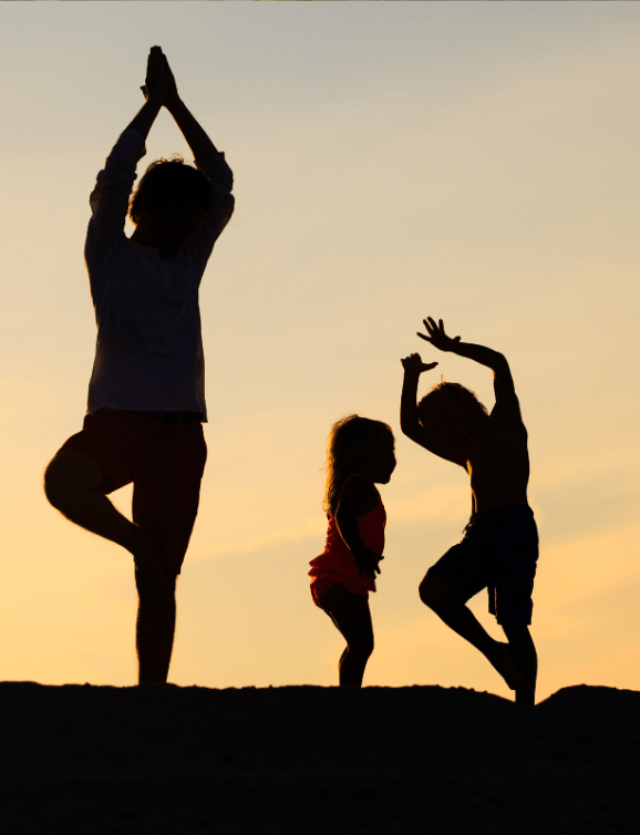 Family doing yoga in the evening