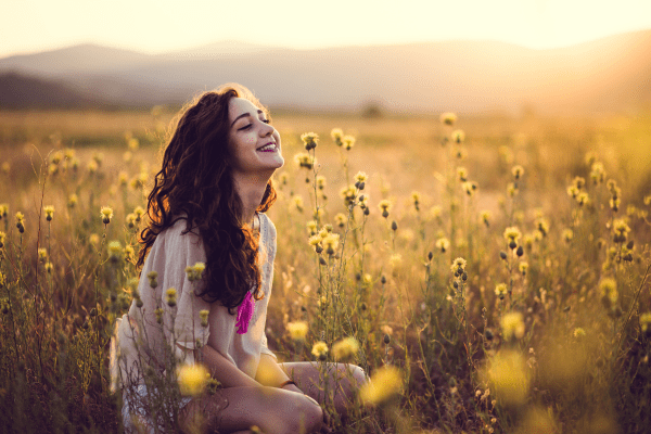 Woman smiling in field of flowers