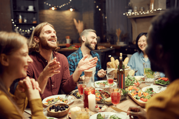 People laughing at a dinner table