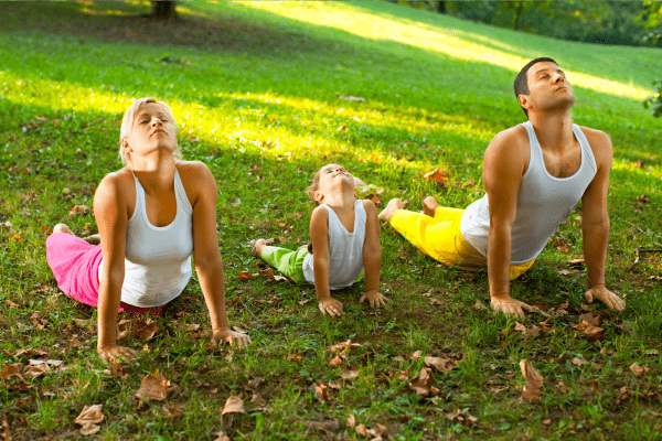 Family doing Yoga Outdoors