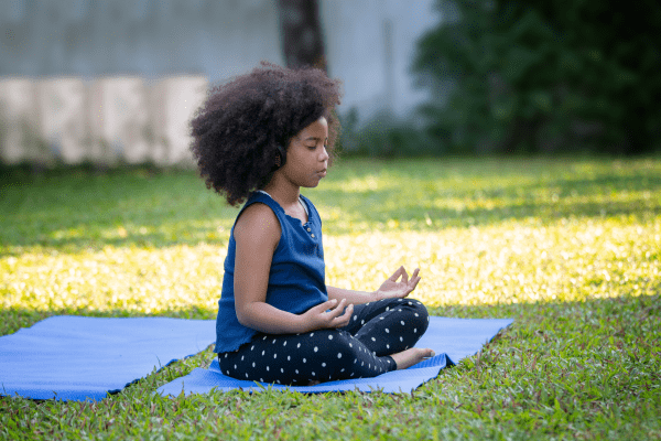 Child Meditating in Yoga Pose